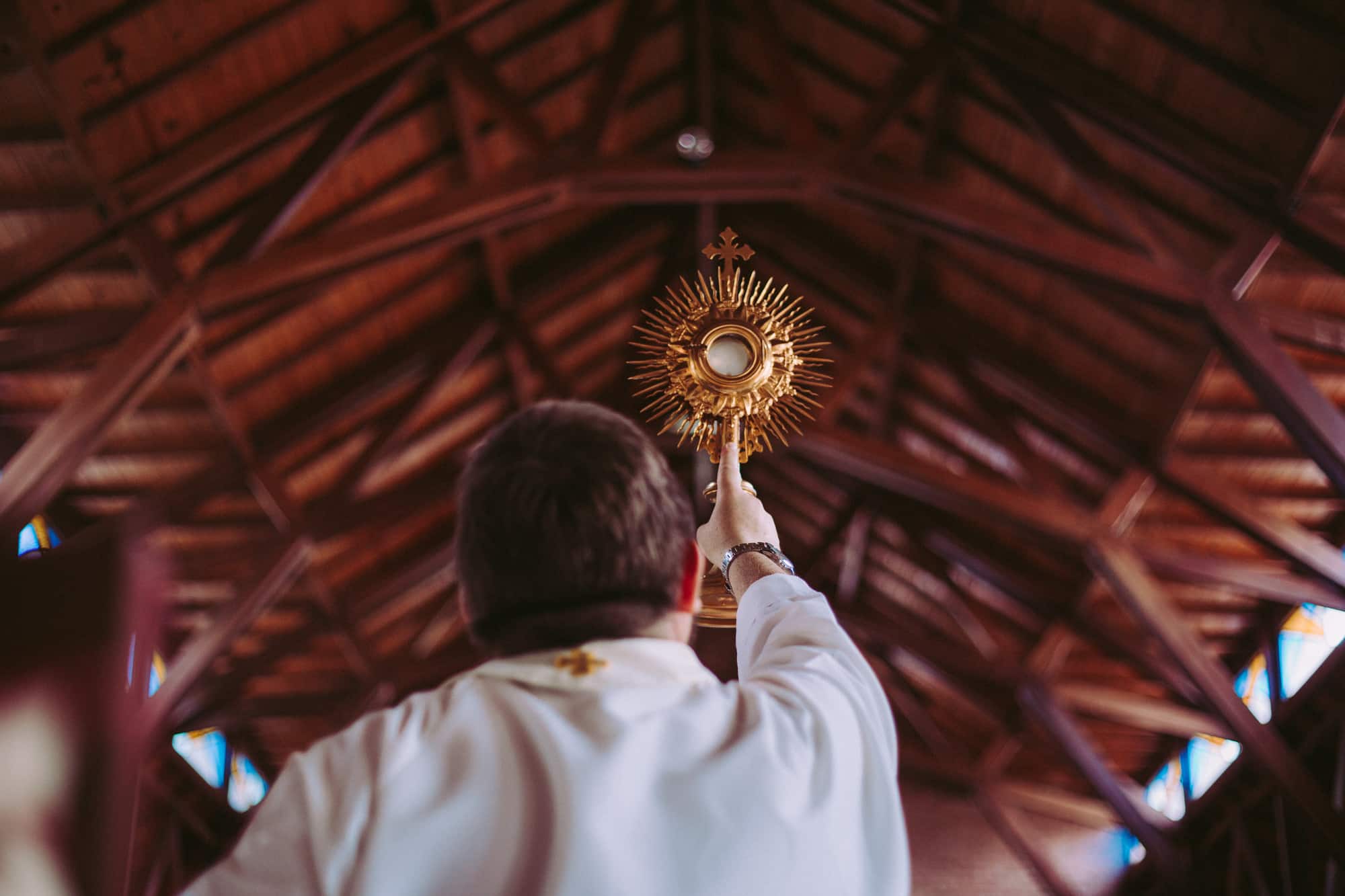 Image of the Blessed Sacrament held by a priest. Discover the meaning of the Eucharist, Mass, and our participation in it in our article on the 100 Saint quotes about the Catholic Mass. Find Mass, adoration, and confession schedules near you on the Catholic Mass Times app on your cell phone.